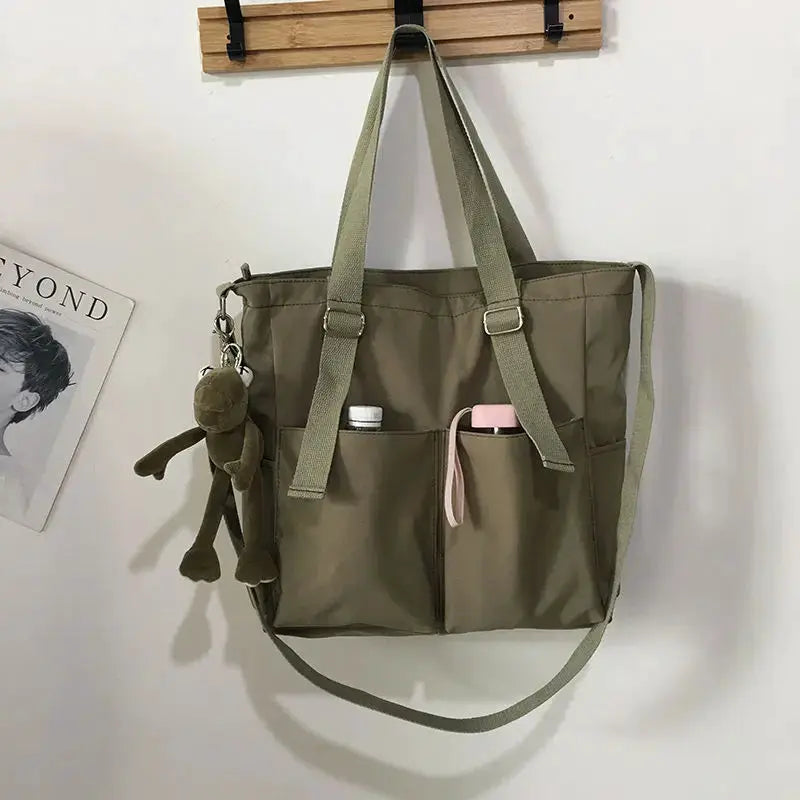 Waterproof Oxford tote bag in olive; large-capacity with dual handles and long strap; front pockets hold bottles.
