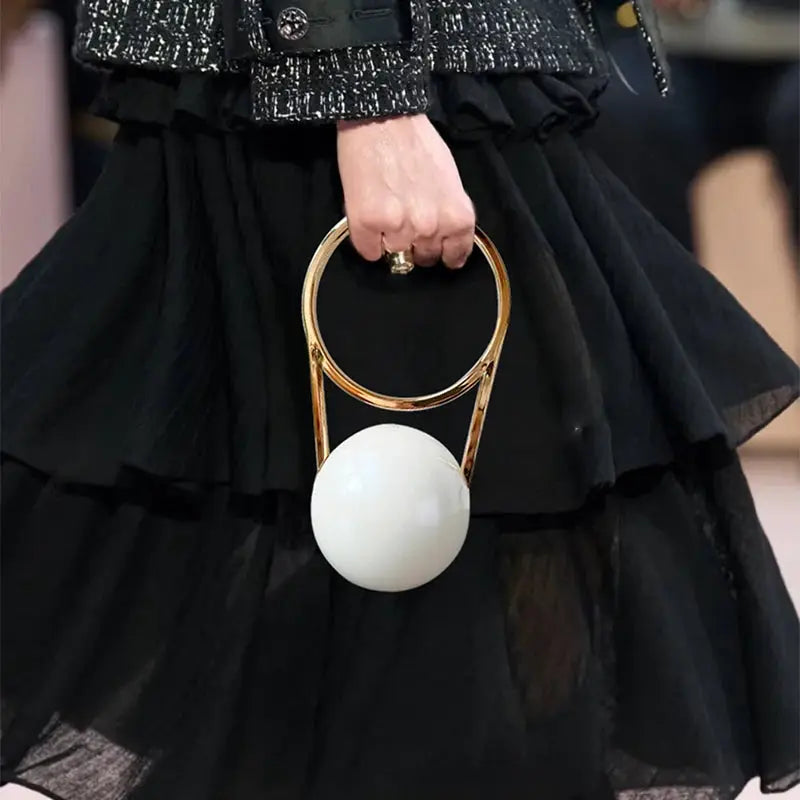 Luxury designer evening clutch by Simples Market, acrylic with gold ball-handle and white sphere