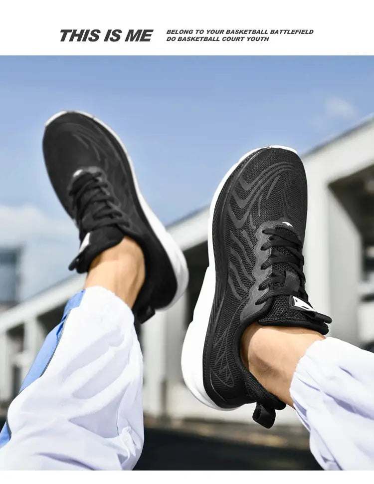 Pair of men's black running shoes with breathable mesh upper and white cushioned soles.