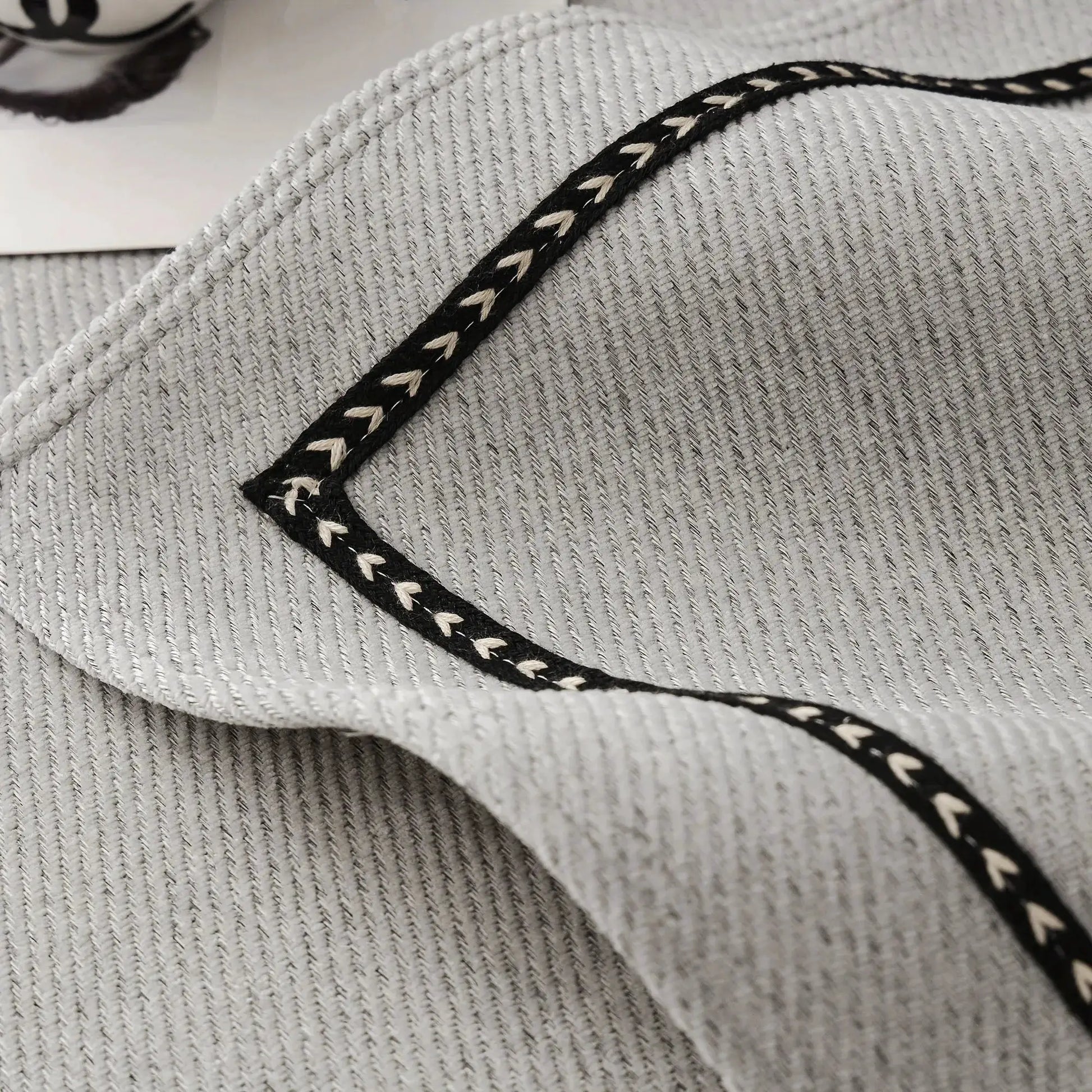 Vintage-style chenille sofa slipcover in gray with black-and-white braided trim, Simples Market