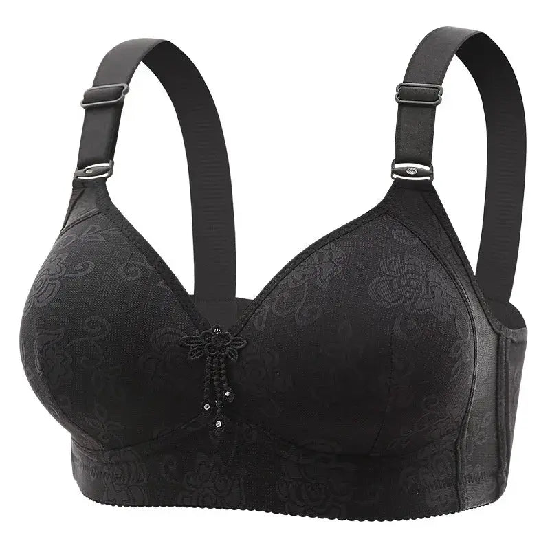 Padded black non-wired bra with subtle floral pattern, wide adjustable straps and center embellishment