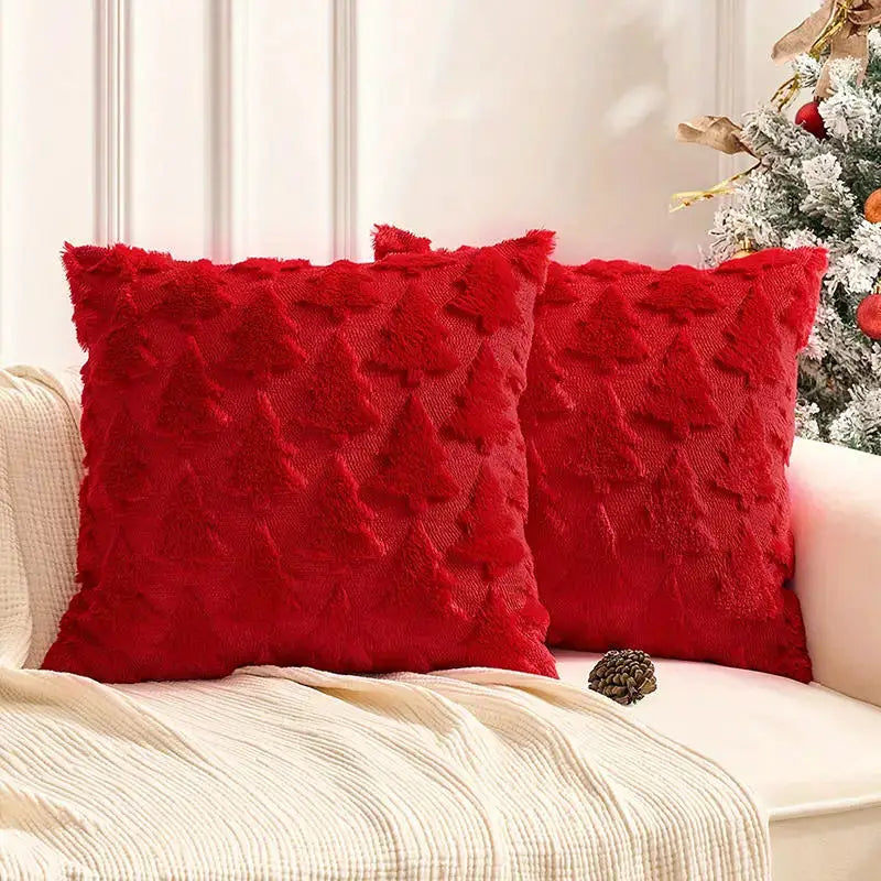 2 red Christmas decorative pillows with textured tree pattern on cream sofa