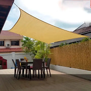 2x3m outdoor sunshade net in beige by Simples Market over a patio dining table and chairs