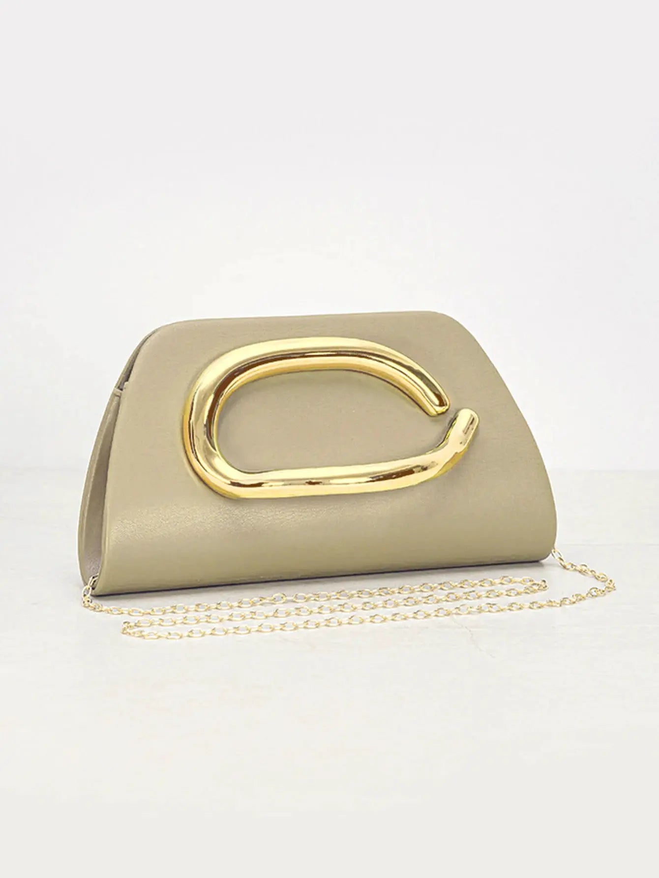 Beige box clutch with large gold-tone buckle and chain strap