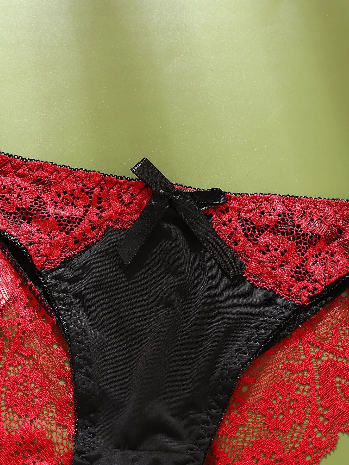 Sexy lace women’s underwear: red lace with black satin panels and a black bow, mid-rise briefs