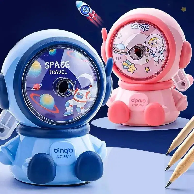 Two astronaut cartoon pencil sharpeners, blue and pink, hand-crank manual sharpeners for school desks.