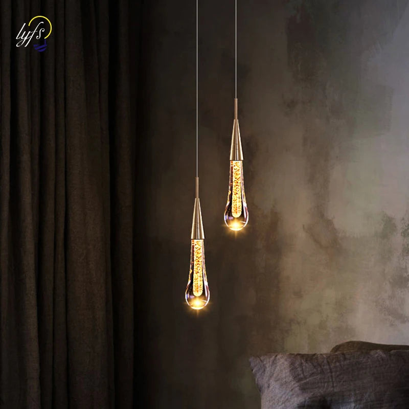 Crystal LED pendant lights; twin brass-finished hanging lamps with warm filament bulbs