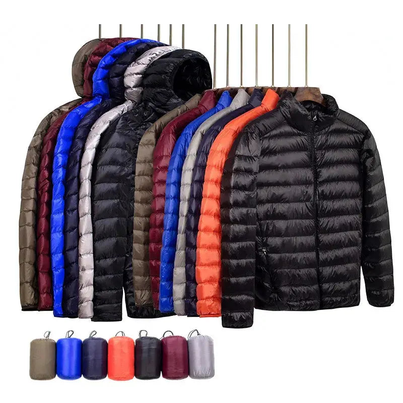 Simples Market men's down jacket collection; super light hooded puffer coats in assorted colors on hangers.