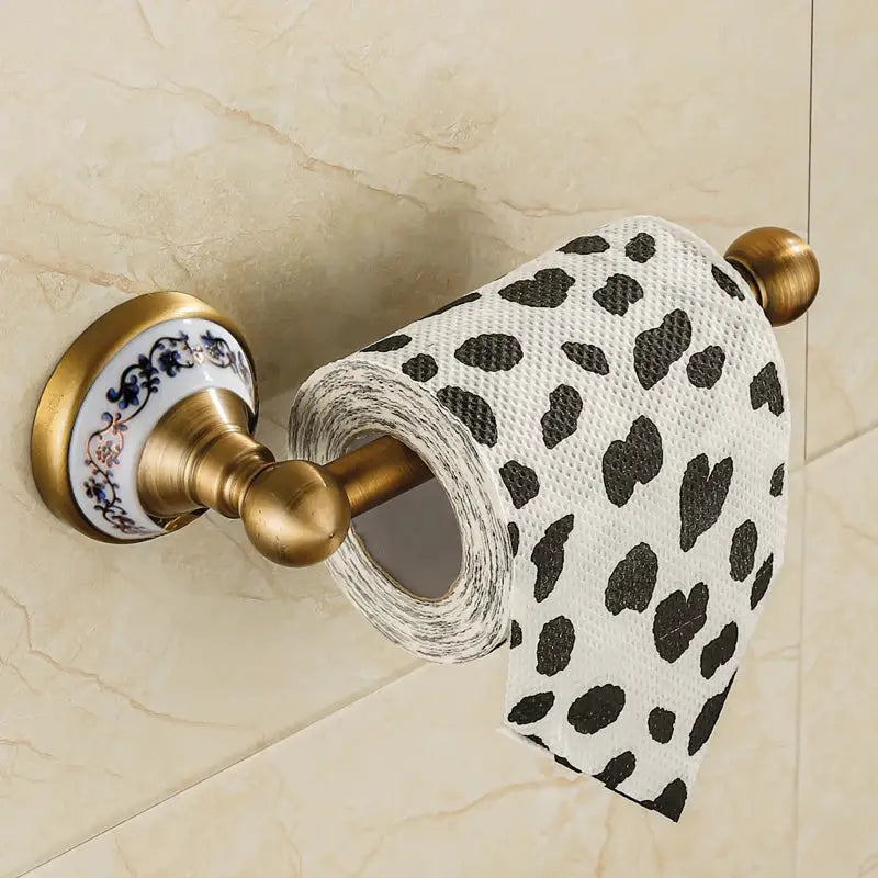 Antique brushed brass toilet paper holder with porcelain blue floral mount