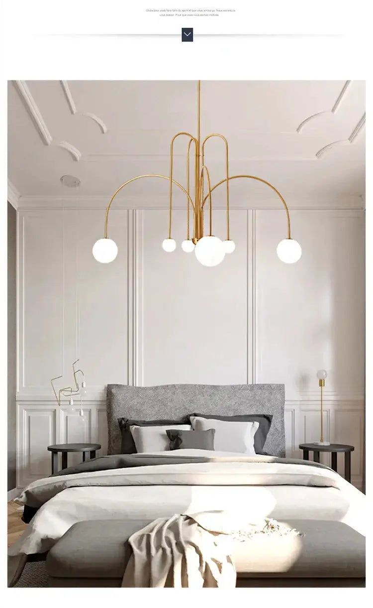 Nordic minimalist pendant light chandelier in gold with white globe bulbs.