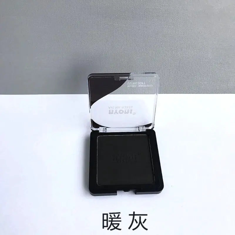 Charcoal drawing powder compact in warm gray by Simples Market
