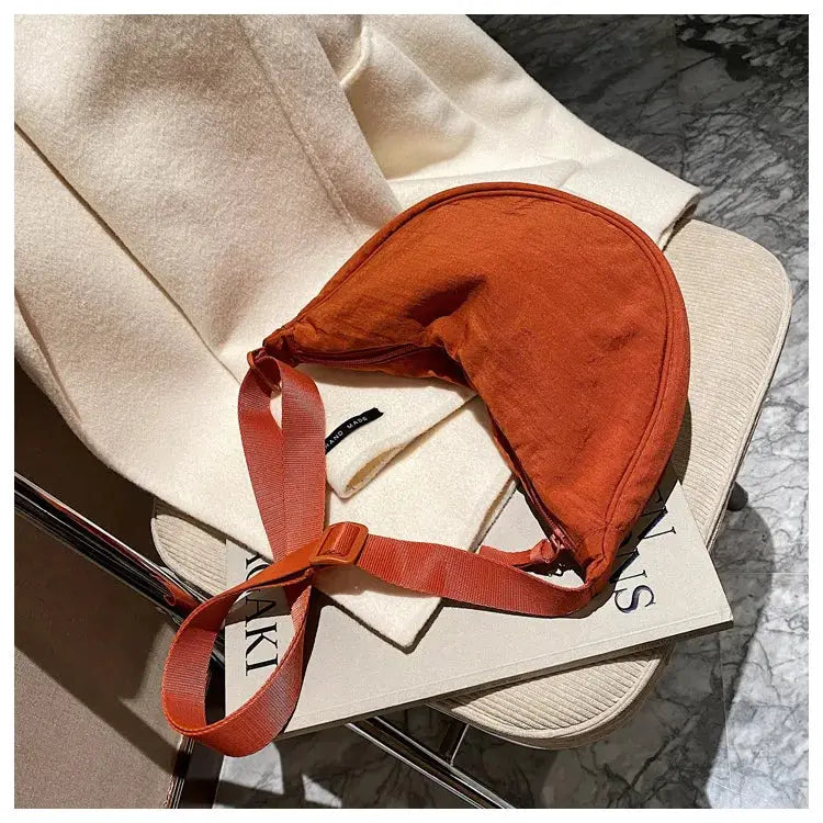 Simples Market casual nylon hobo crossbody bag for women in burnt orange with adjustable red strap, large capacity.