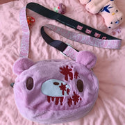 Gloomy Bear plush crossbody bag in pink with blood-splatter details, by Simples Market.