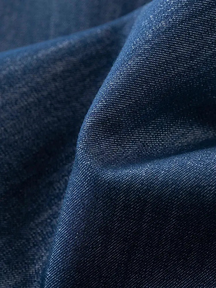 Denim fabric close-up in navy blue with visible weave texture