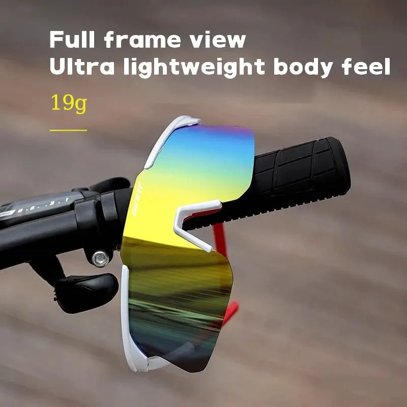 Cycling glasses with white TR90 frame and gradient rainbow mirrored lenses on a bike handlebar