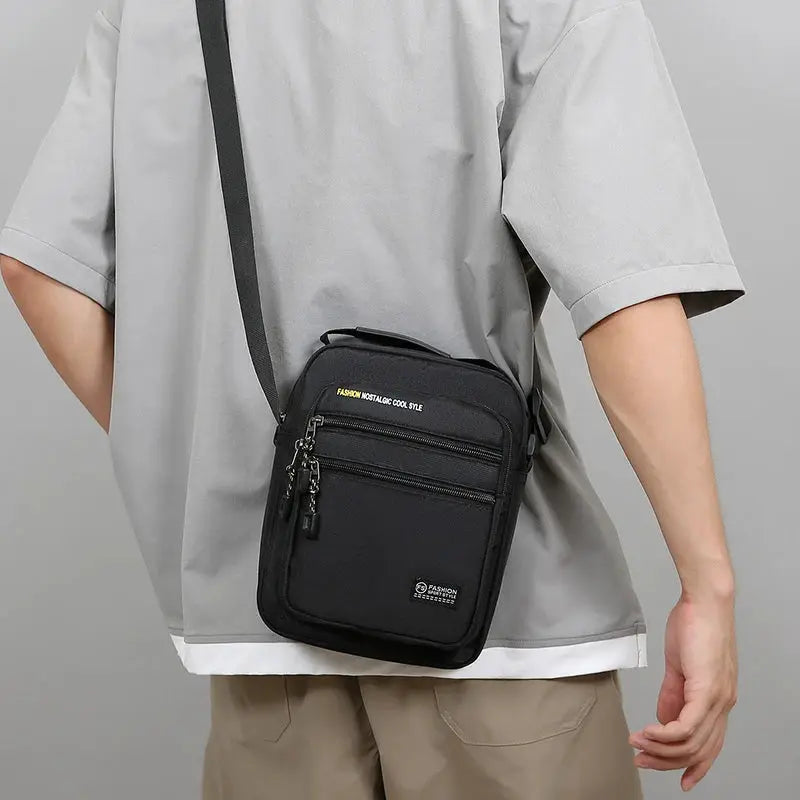 Simples Market black Oxford crossbody bag with multiple zip pockets and single shoulder strap
