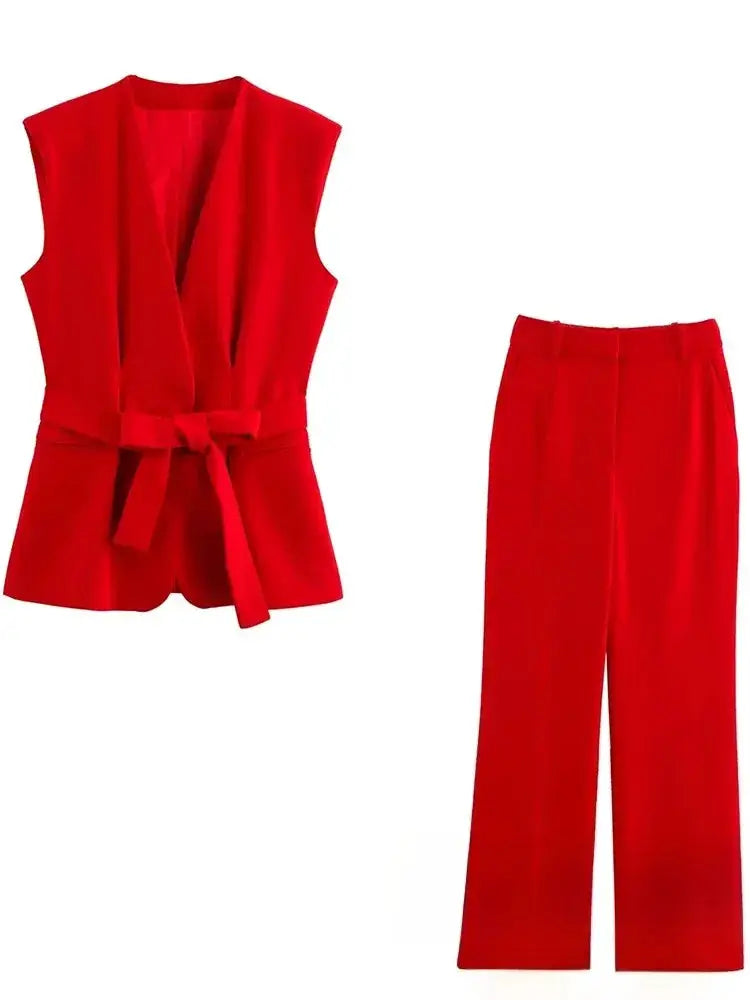 Red sleeveless V-neck blazer with waist sash and matching high-waist wide-leg pants set.