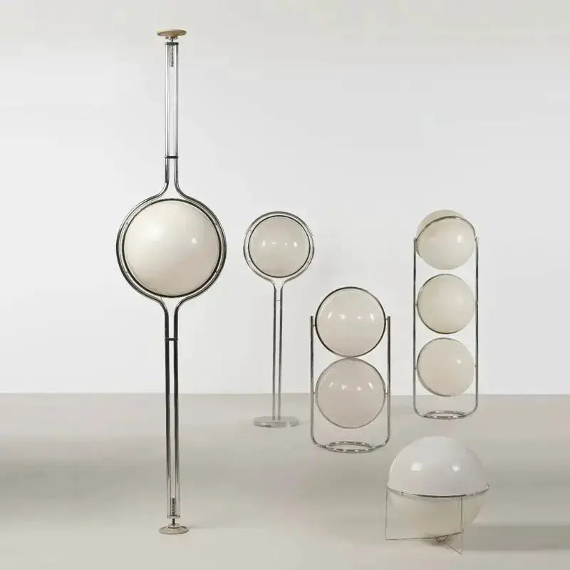 Five-piece set of modern white acrylic circular globe lamps in chrome frames, including a tall floor lamp and several globe lamps.