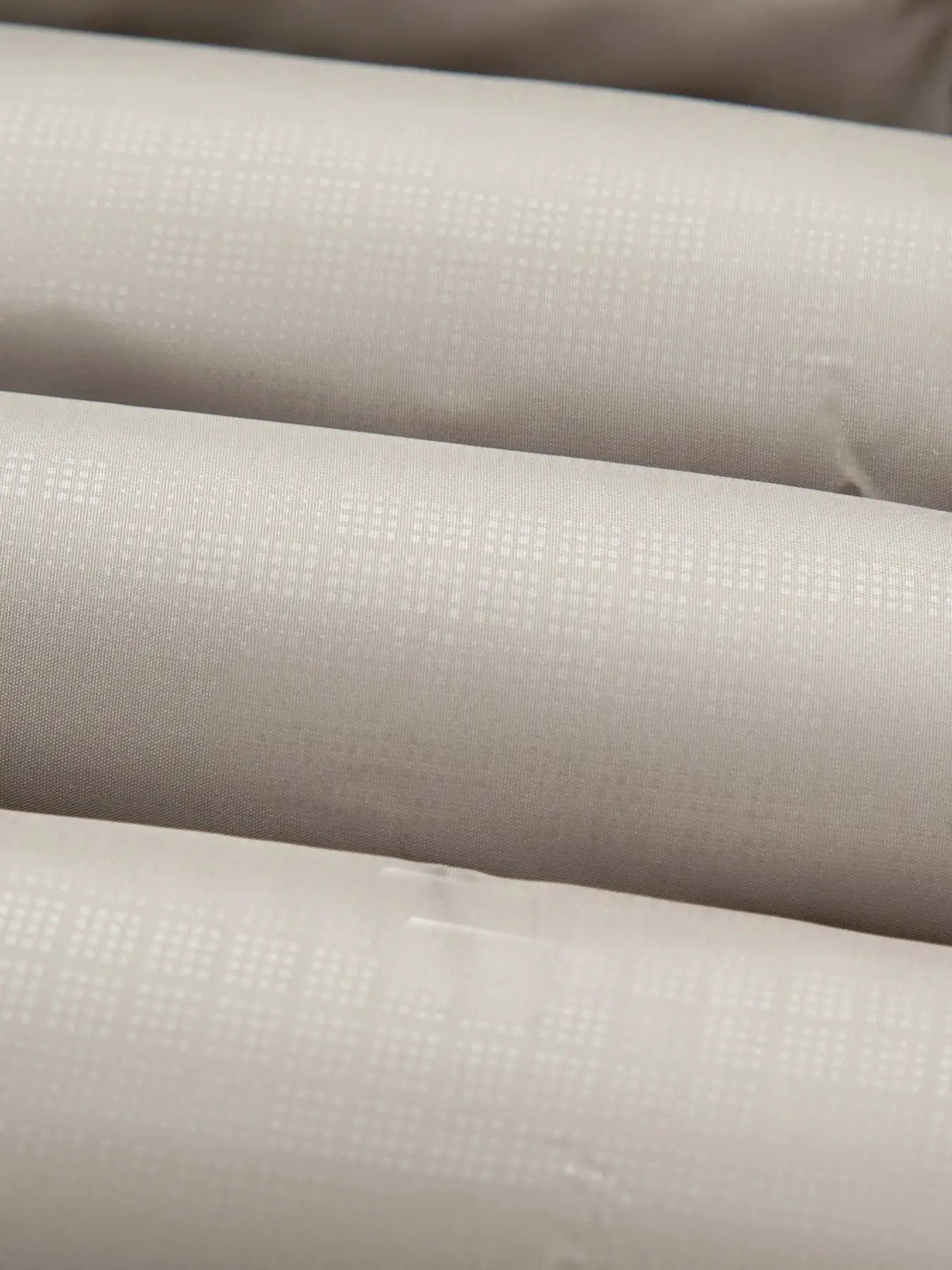 Men's cotton jacket fabric close-up in ivory with a subtle dotted weave pattern.