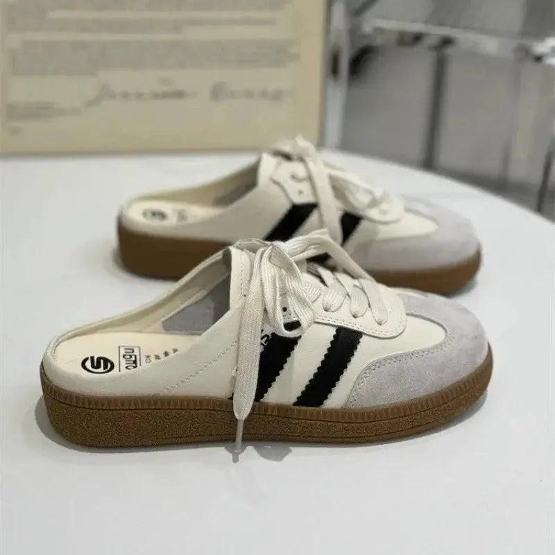 Women casual sneakers with white upper, black side stripes, grey toe, and gum sole