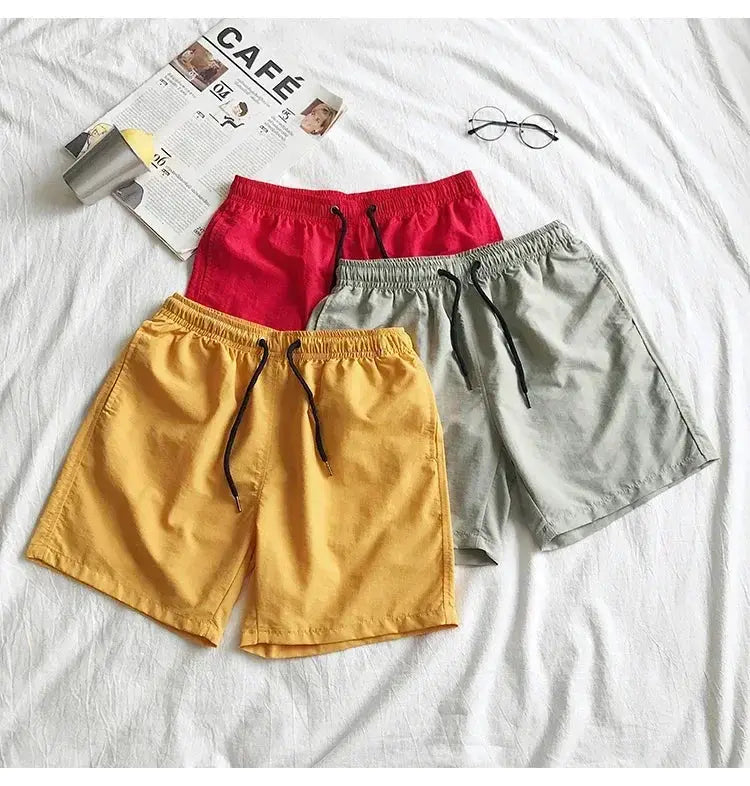 Men's swim shorts in four colorways (yellow, red, gray, light gray) with black drawstrings