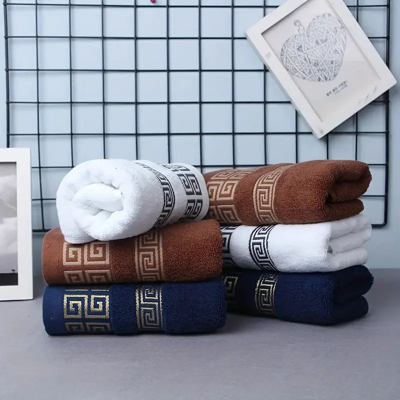 Six-piece 100% cotton bathroom towel set in white, brown, and navy with Greek key embroidered borders