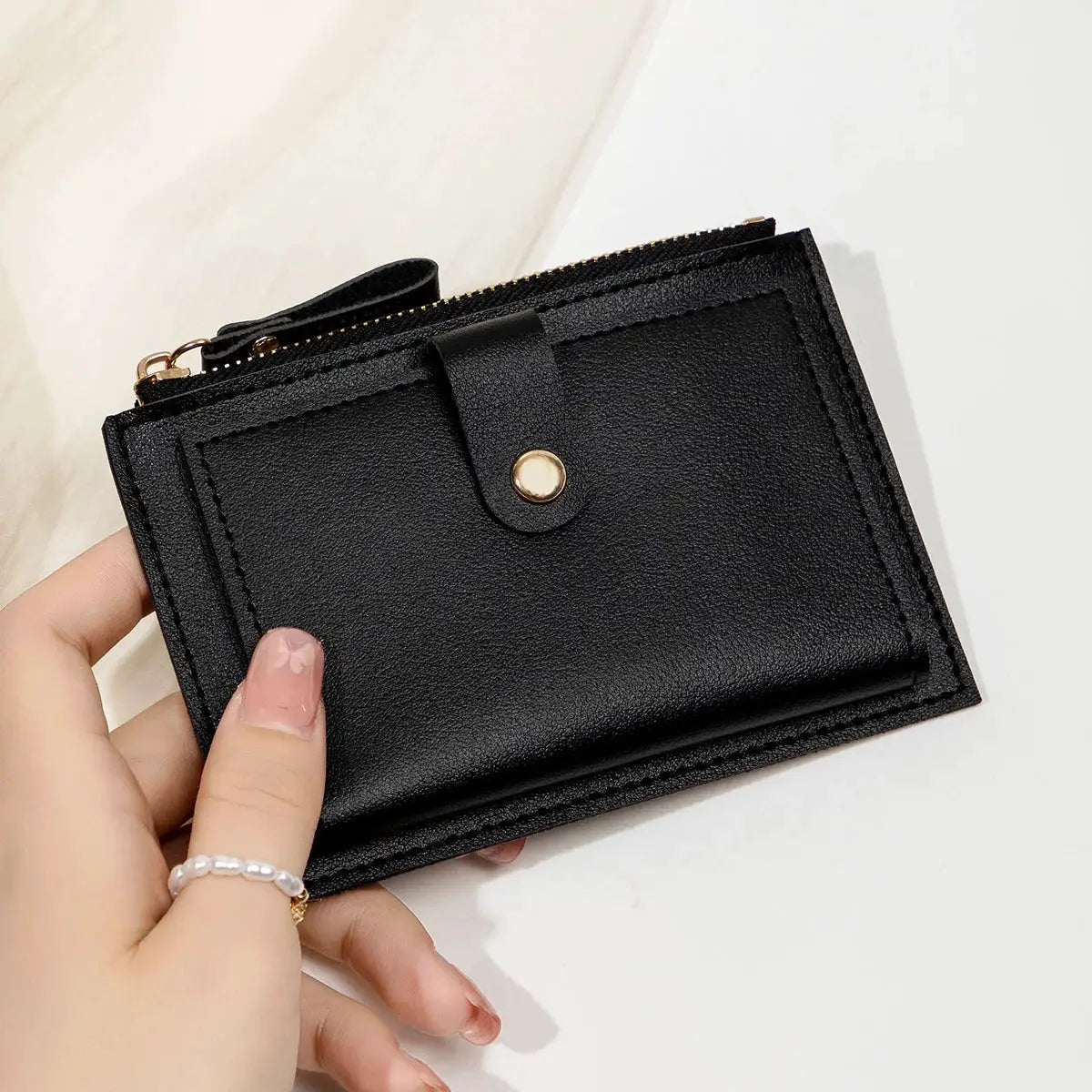 Card wallet, minimalist black ultra-thin PU leather with zip and snap strap.