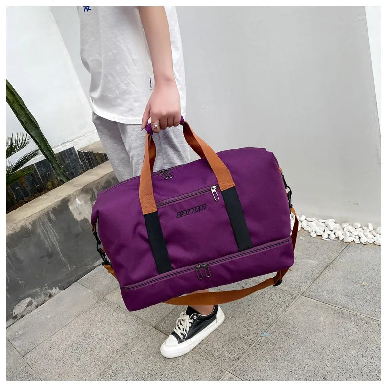 Gym bag in purple with tan handles and black straps, large-capacity travel bag with multiple zip pockets.