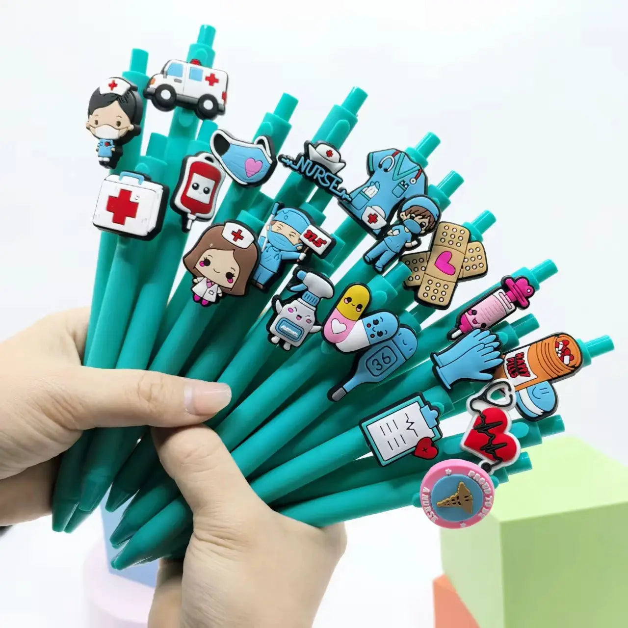 Nursing-themed teal ballpoint pens by Simples Market, 20–30 pcs with medical icons.