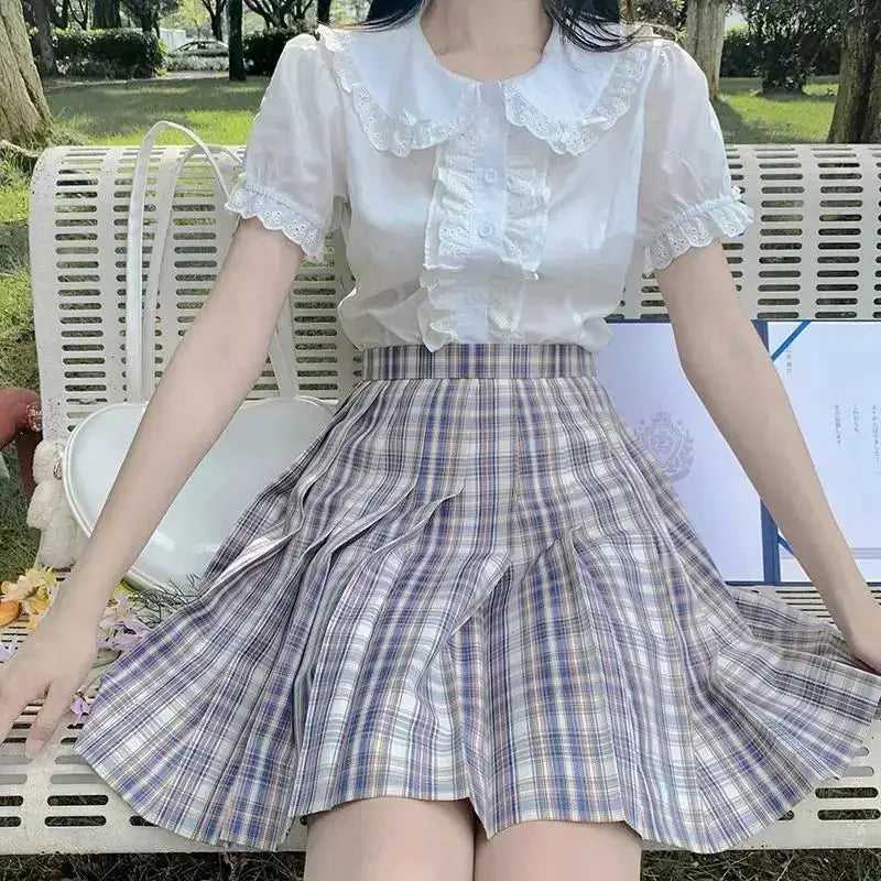 Deeptown white lolita blouse with lace collar and puff sleeves, paired with a plaid skirt outdoors