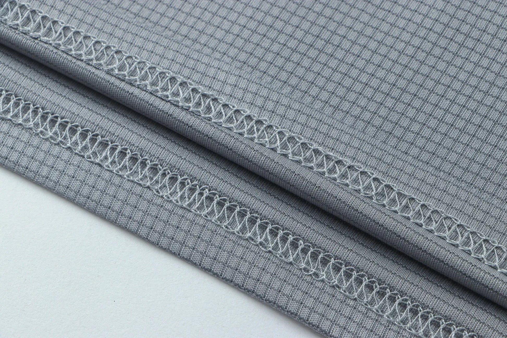 Men's athletic T-shirt fabric in gray; moisture-wicking knit with reinforced seam stitching