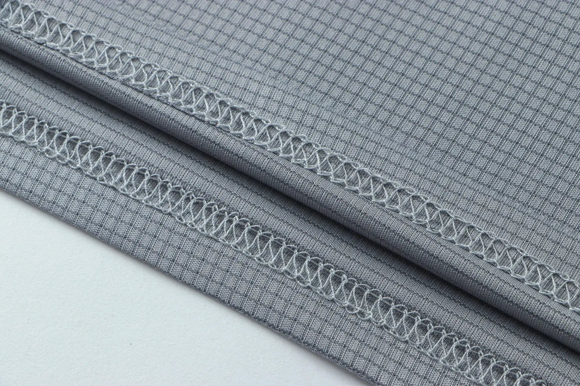 Men's athletic T-shirt fabric in gray; moisture-wicking knit with reinforced seam stitching