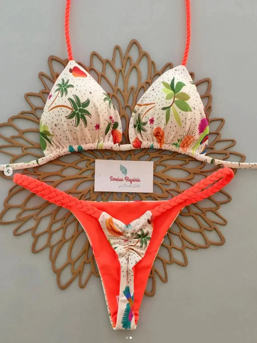 Two-piece micro bikini set with tropical palm print, white base and neon coral braided straps; brand Sereias Biquinis