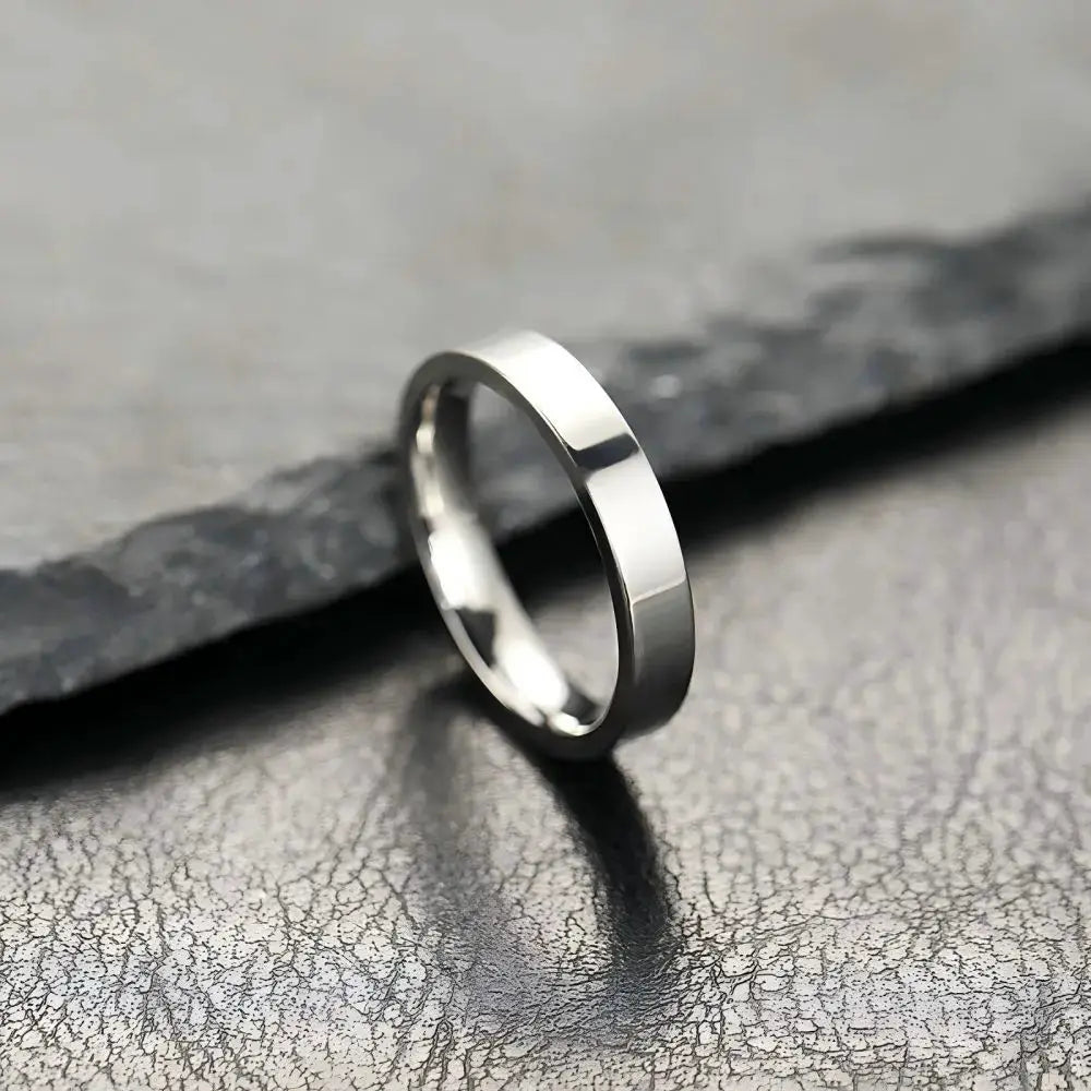 Unisex stainless steel ring with black matte finish; simple flat-band fashion jewelry.