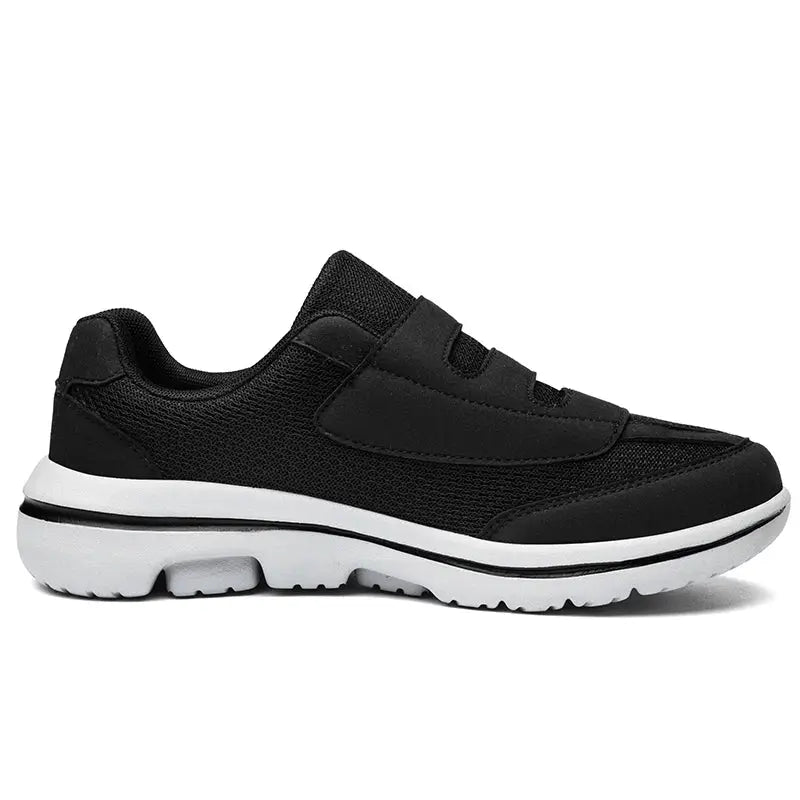 Wide-toe black sneaker with hook-and-loop straps and white sole, orthopedic diabetic footwear