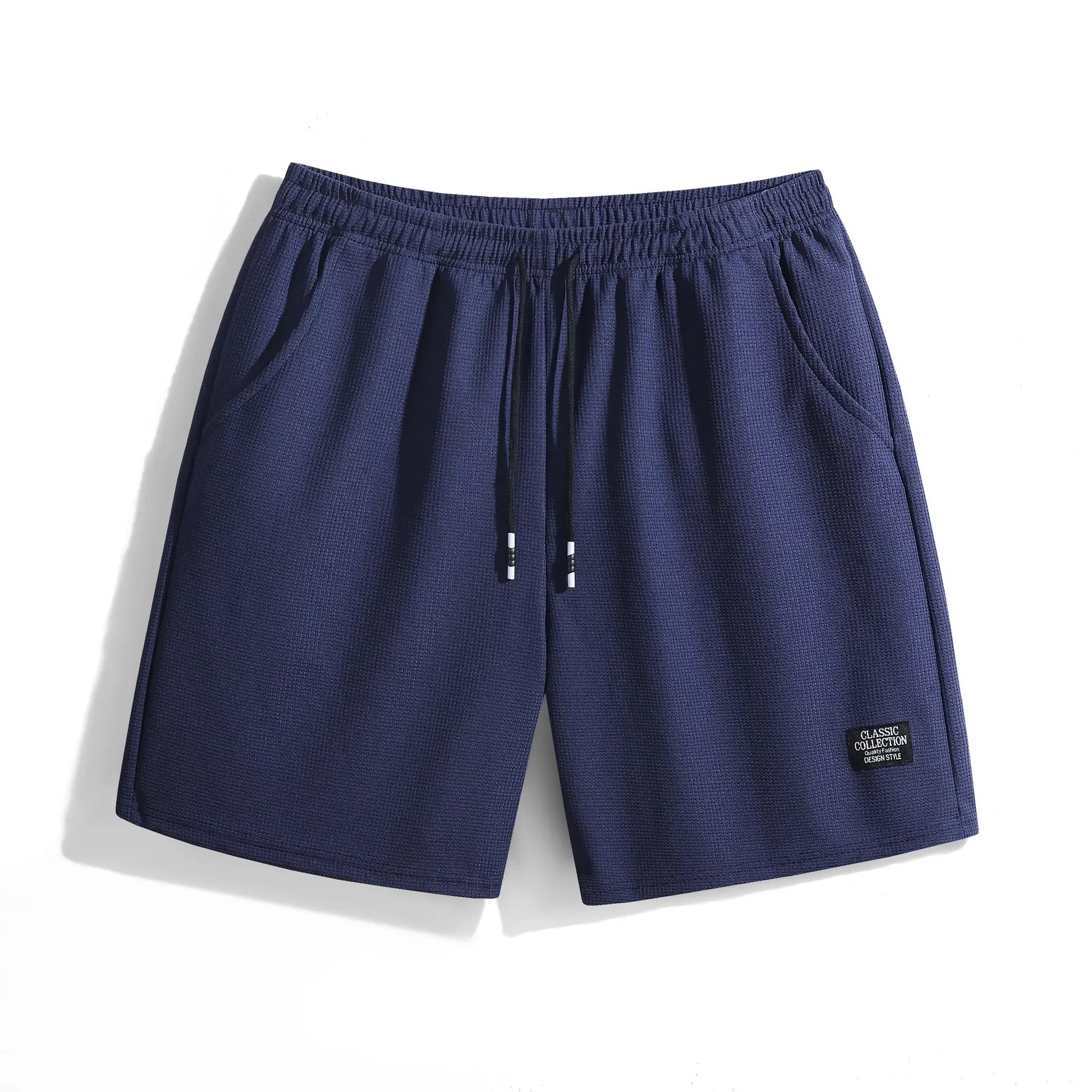 Navy blue men's shorts with elastic waistband and drawstring with white tips, textured fabric.