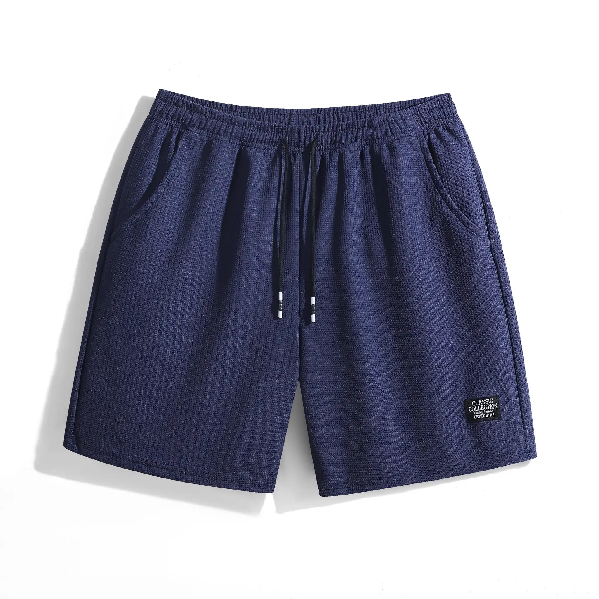 Navy blue men's shorts with elastic waistband and drawstring with white tips, textured fabric.