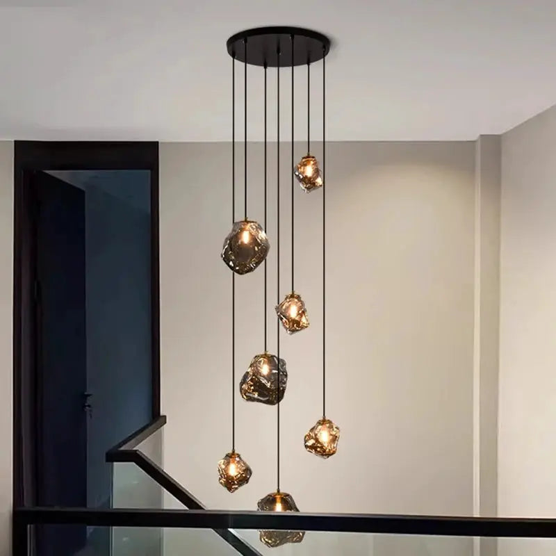 Pendant light by Simples Market with multiple amber glass bulbs for living room and staircase