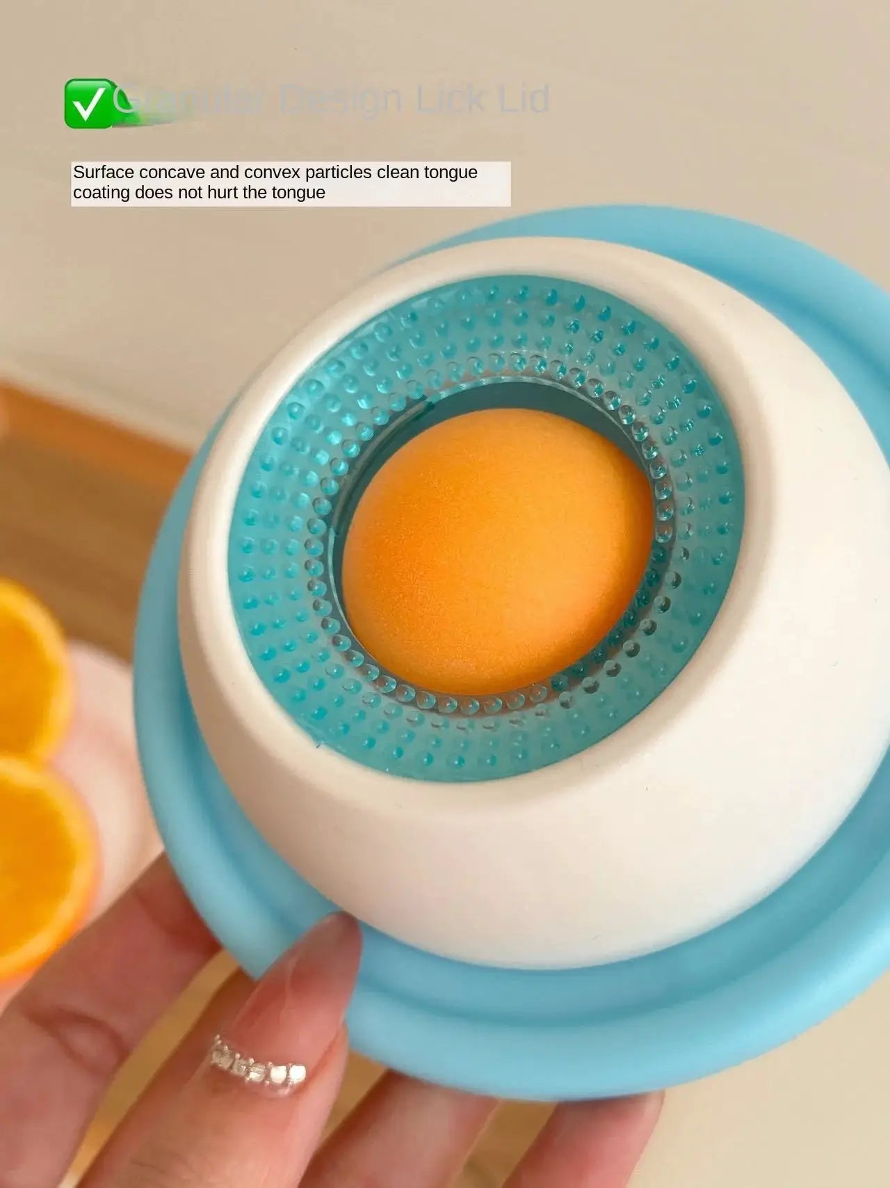 Lick toy for dogs, blue interactive slow-feeder with teal textured ring and orange ball.