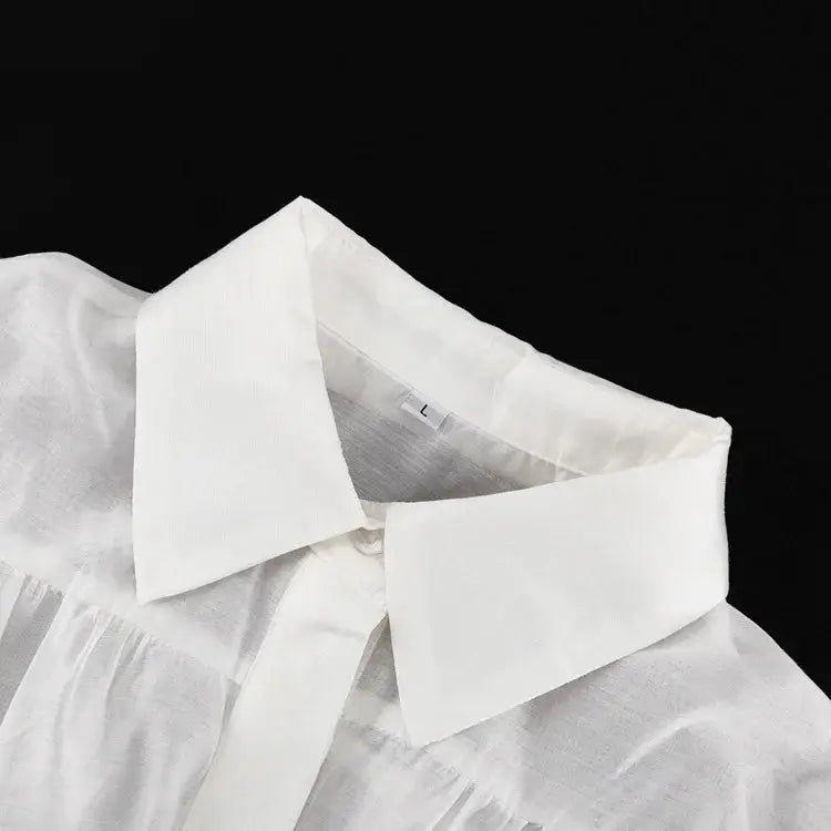 White women's collared shirt with a large collar and long sleeves.