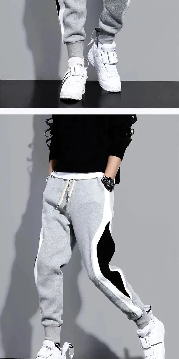 Men's grey patchwork jogger pants with white side panels and drawstring waist, casual sportswear