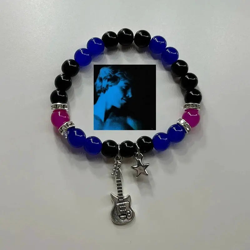 Beaded bracelet for couples with black/blue/magenta beads, silver spacers, guitar and star charms, and a photo insert