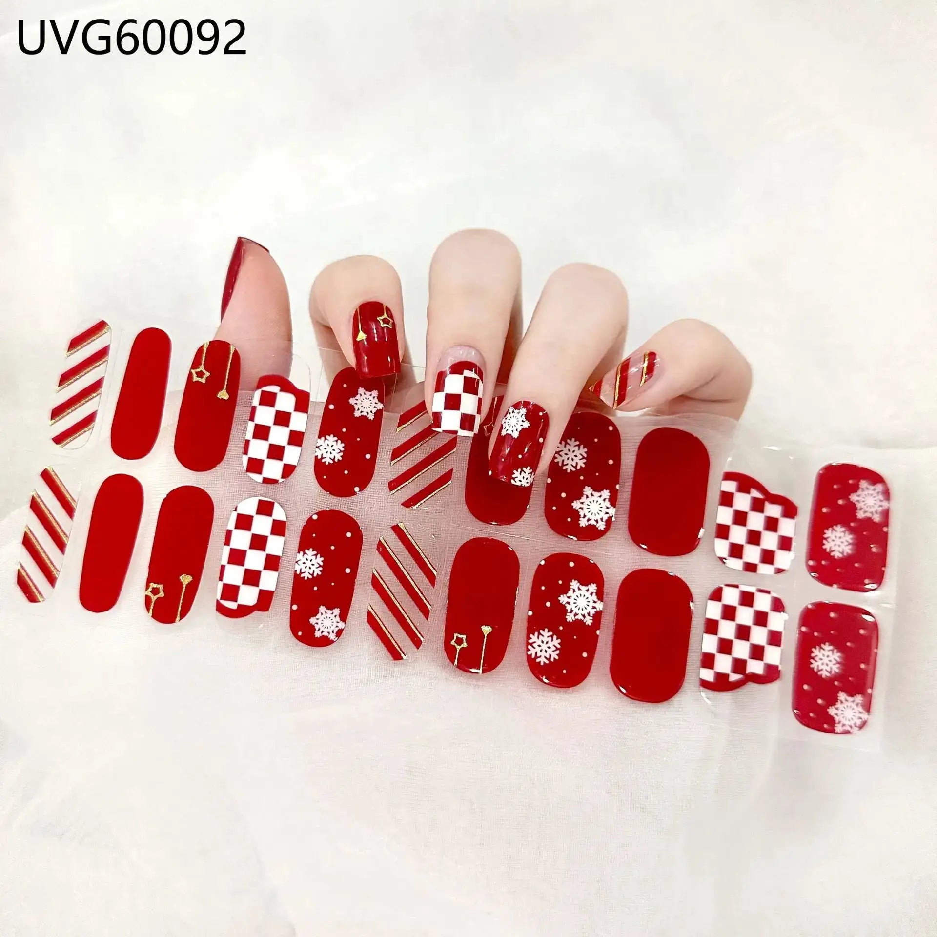 Gel nail wrap set with red and white patterns for full-cover manicure; checkerboard, stripes, and snowflakes