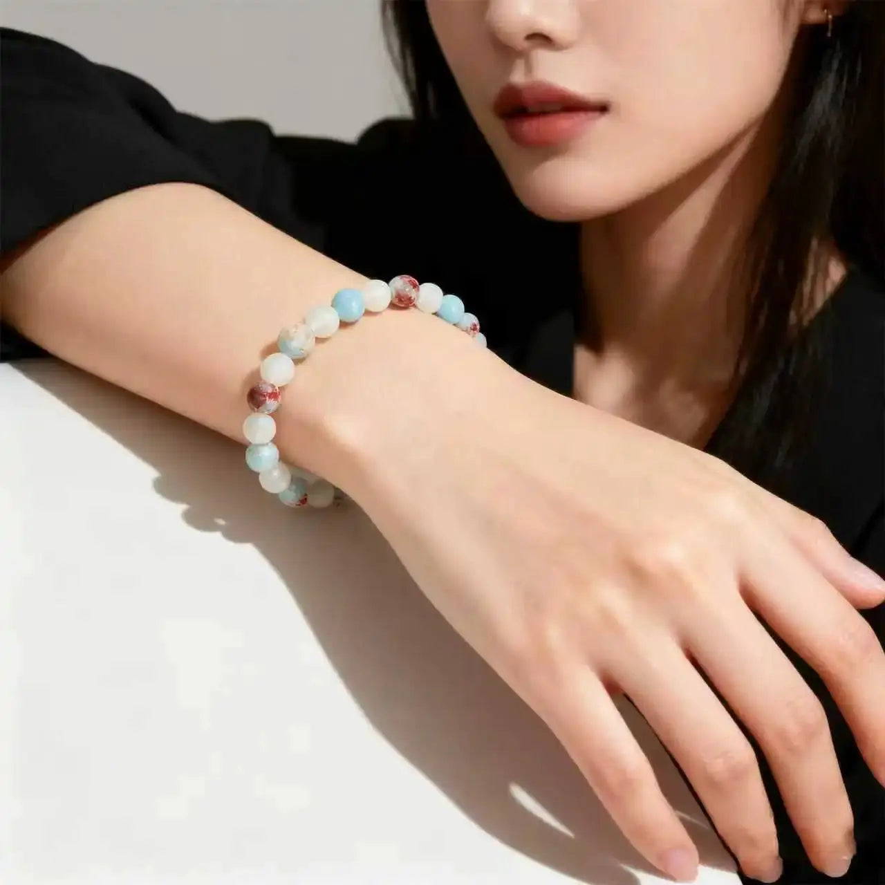 Halo Quartz Ocean Sediment beaded bracelet for unisex, with pastel blue and white beads on the wrist