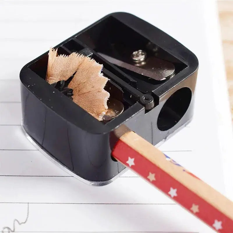 Simples Market double-hole lipstick cosmetic pencil sharpener, black plastic with two sharpening holes.