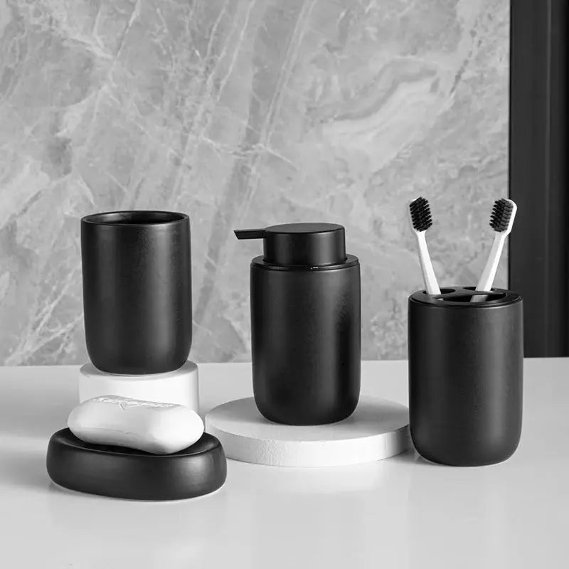 Matte black ceramic bathroom set with mouthwash cup, pump bottle, toothbrush holder, and soap dish (four-piece)