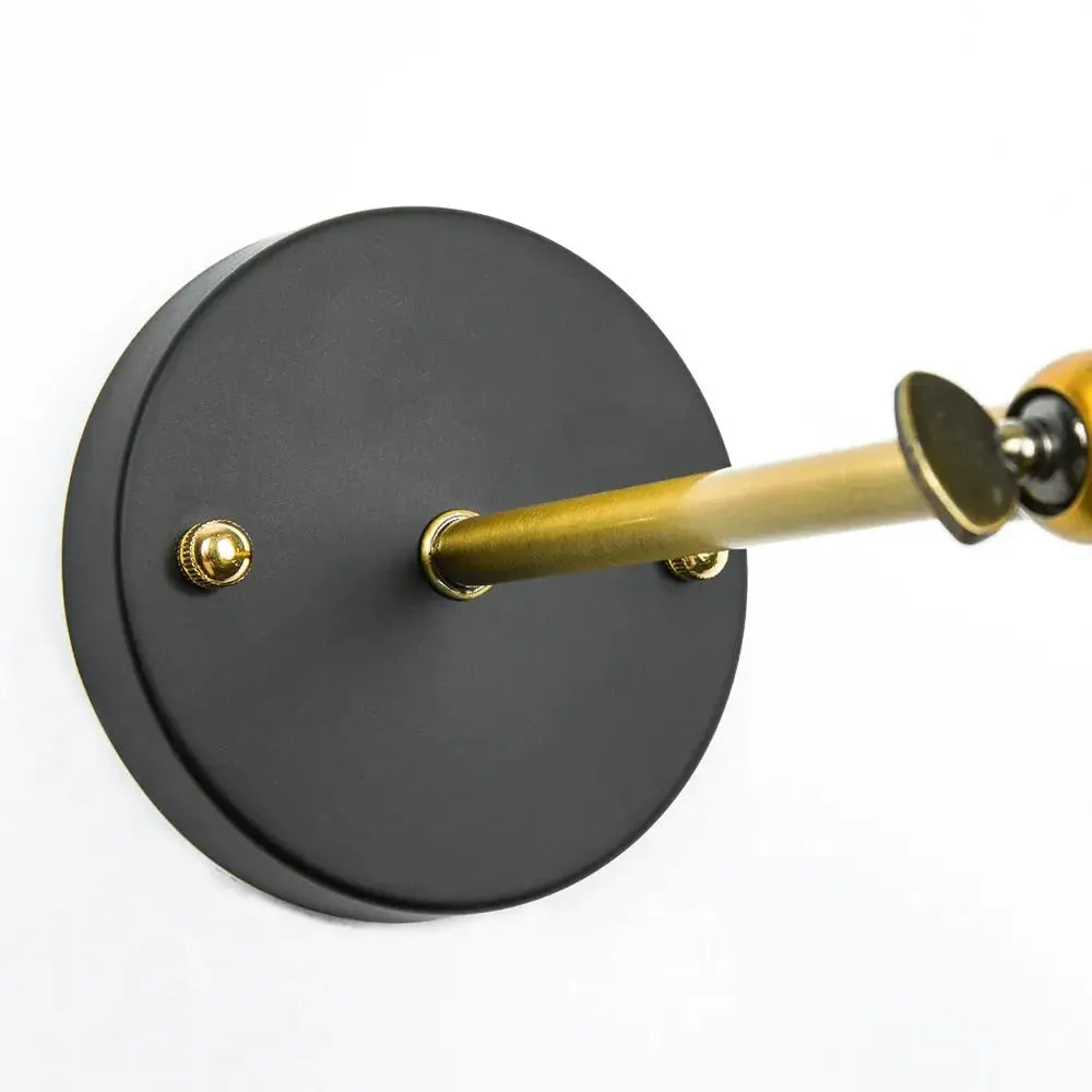 American single head wall lamp by Simples Market, industrial black round backplate with brass arm.