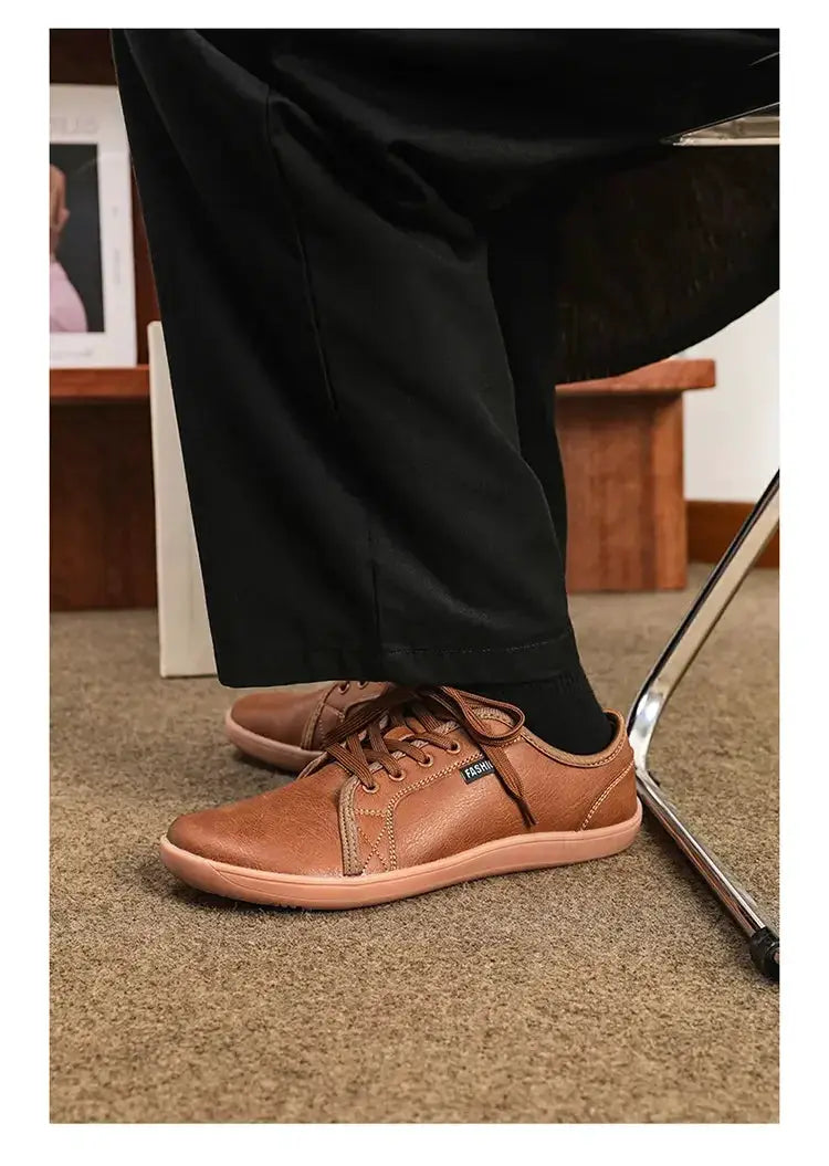 Wide-version barefoot walking shoes; unisex brown leather-like lace-up sneakers with light tan sole.