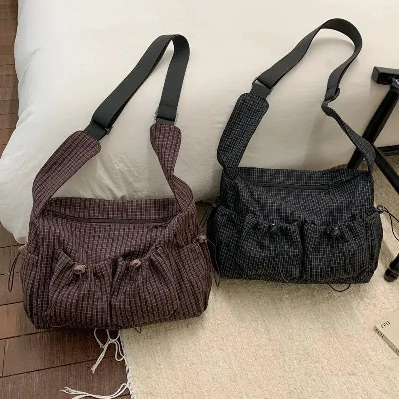 Two Simples Market nylon plaid shoulder bags, brown and black, with drawstring pockets and front zippers