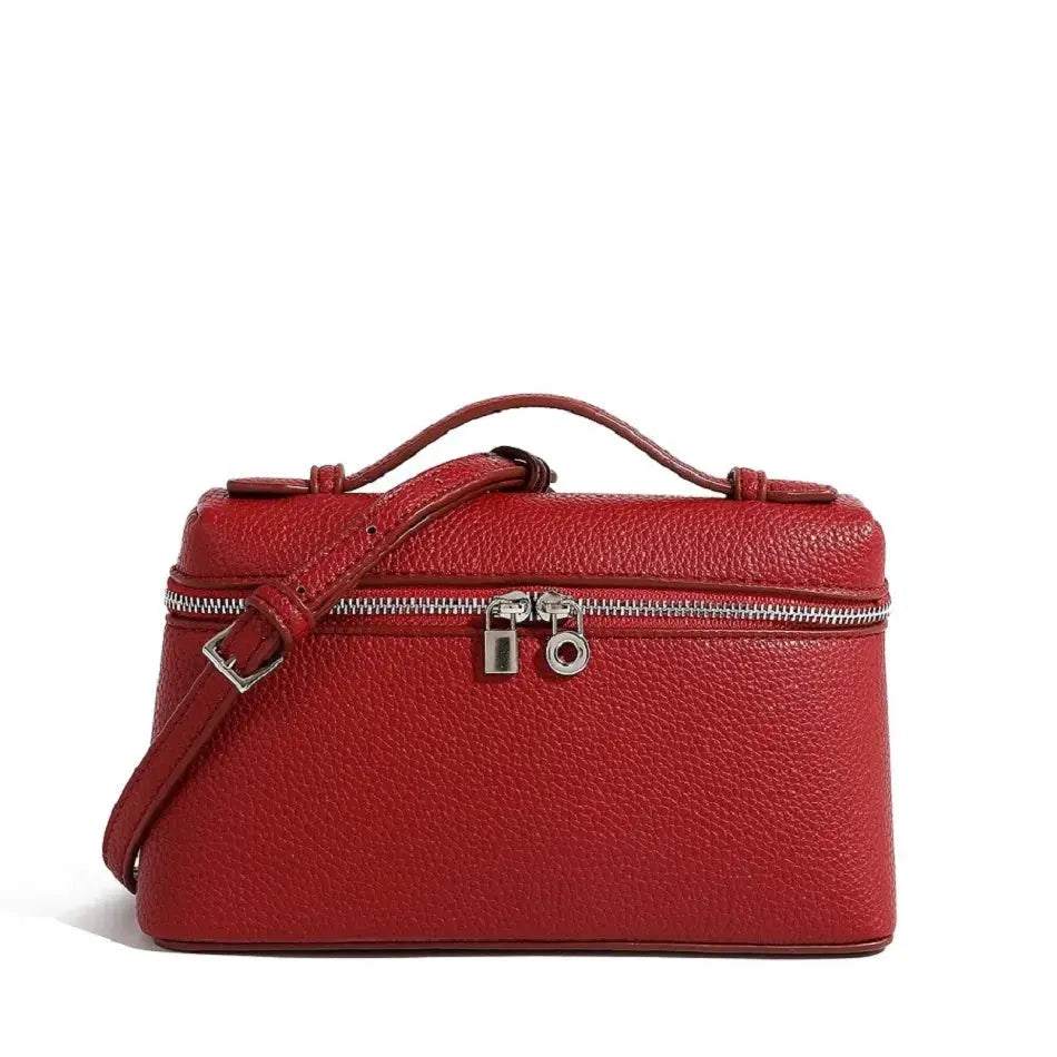 Red pebble-grain mini shoulder bag with top handle, crossbody strap and silver zippers.